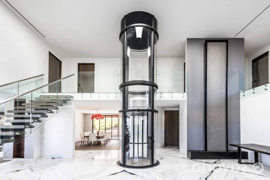 Round clear elevator in center of home entryway